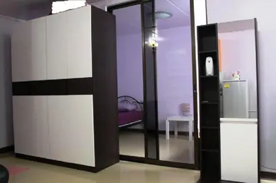 a room with a sliding glass door with a refrigerator at Poppular Palace Don Mueang Bangkok in Bangkok