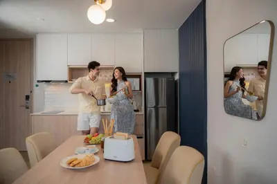 a man and a woman standing in a kitchen at Staybridge Suites Bangkok Thonglor by IHG in Bangkok