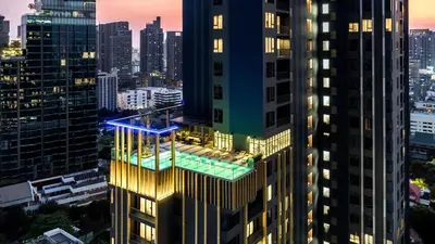 a building with a pool on the side of it at Staybridge Suites Bangkok Thonglor by IHG in Bangkok