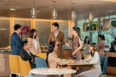 a group of people sitting around a table in a restaurant at Staybridge Suites Bangkok Thonglor by IHG in Bangkok