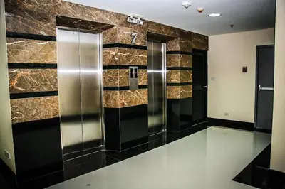 a public restroom with two elevators in a building at 42Grand Residence in Bangkok