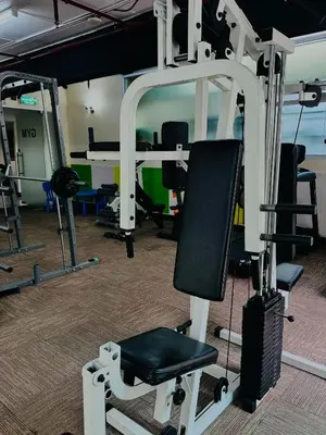 a gym with a treadmill and a chair at 42Grand Residence in Bangkok