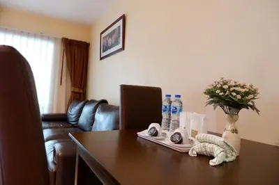 a table with a vase of flowers on top of it at 42Grand Residence in Bangkok