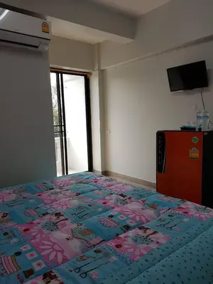 a bedroom with a bed with a colorful quilt on it at Vanlisut Hotel Ngamwongwan in Nonthaburi