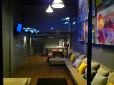 a living room with a couch and a table at In a Box Hostel in Bangkok