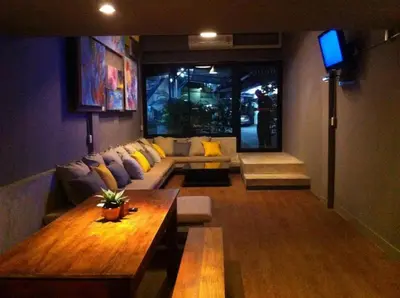 a living room with a couch and a table at In a Box Hostel in Bangkok