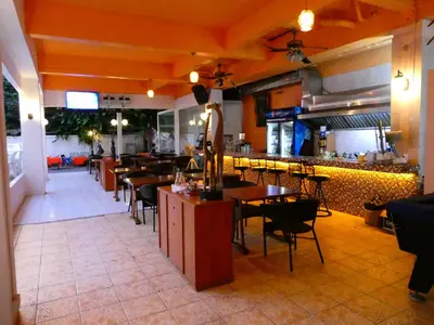 a dining room with tables and chairs in a restaurant at MANGO Lagoon Place in Bangkok