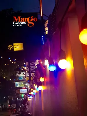 a city street with street lights at night at MANGO Lagoon Place in Bangkok