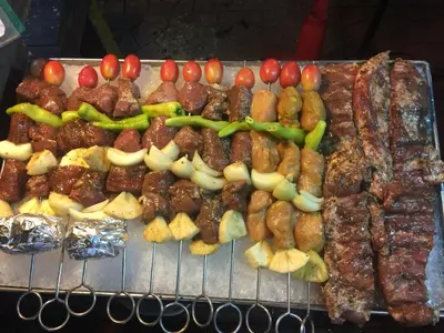 a bunch of different types of food on a grill at MANGO Lagoon Place in Bangkok