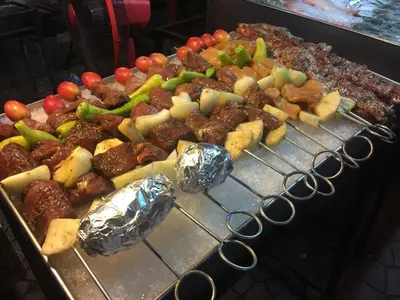a grill with many different types of food on it at MANGO Lagoon Place in Bangkok