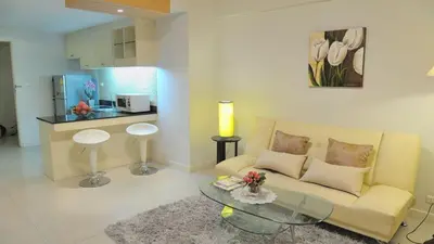 a living room with a couch and a table at Duplex 21 Apartment in Bangkok