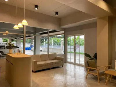 a living room with a couch and a table at Next Bird Suite SHA in Nonthaburi