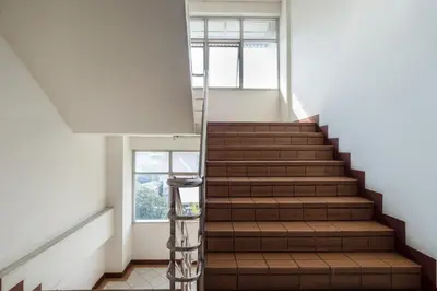 a staircase in a building with a window at Next Bird Suite SHA in Nonthaburi