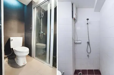 a bathroom with a toilet and a glass shower at Next Bird Suite SHA in Nonthaburi