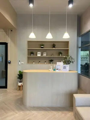 a lobby with a reception counter with lights at Next Bird Suite SHA in Nonthaburi