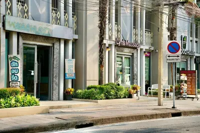 a city street with buildings and signs on the sidewalk at Pentafield City Residence in Amphoe Phra Khanong