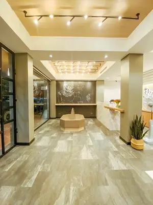 a lobby of a building with a stone floor at YAKTHAI POSHTEL in Bangkok