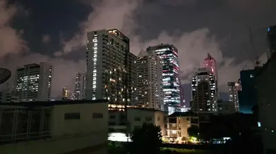 a city skyline at night with tall buildings at Cozy Studio 1 in Sathorn, BTS Saint Louis in Bangkok