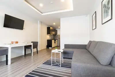 a living room with a couch and a table at Cozy Studio 1 in Sathorn, BTS Saint Louis in Bangkok