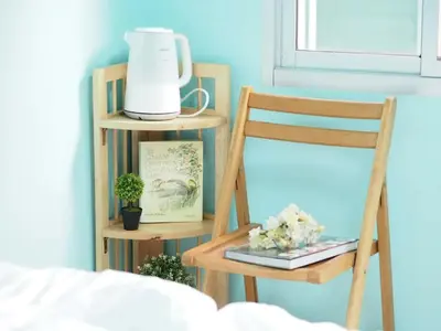 a room with two shelves and a chair and a blender at Makkasan Happy Home in Bangkok