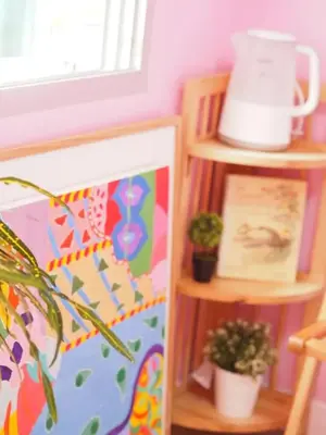 a room with two shelves with plants and a pot at Makkasan Happy Home in Bangkok