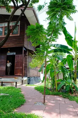 a man looking out of a window of a house at Yesterday Sathon in Bangkok