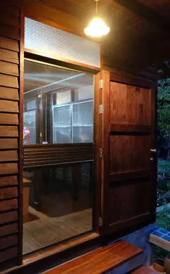 a wooden door with a window in a house at Yesterday Sathon in Bangkok