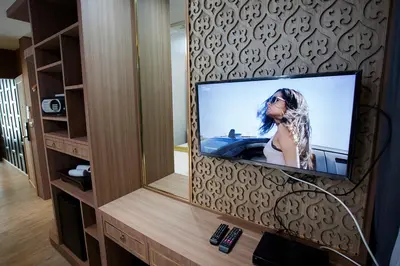 a television in a room with a mirror at GHEE GELATO HOUSE in Bangkok
