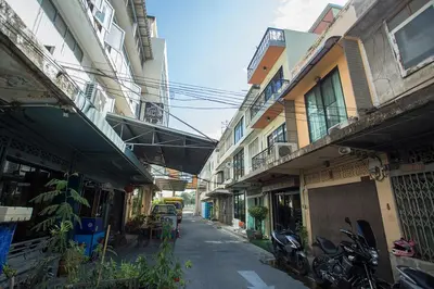 an alley with buildings and a bridge over a street at GHEE GELATO HOUSE in Bangkok