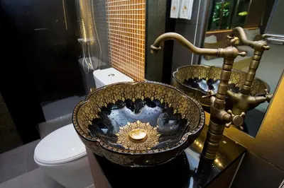 a bathroom with two sinks and a toilet at GHEE GELATO HOUSE in Bangkok