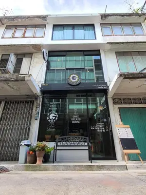 a store with a bench in front of a building at GHEE GELATO HOUSE in Bangkok