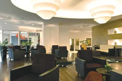 a lobby of a hotel with chairs and tables at The Narathiwas Hotel & Residence Sathorn Bangkok in Bangkok