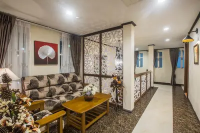 a living room with a couch and a table at Cana Boutique Hotel in Bangkok