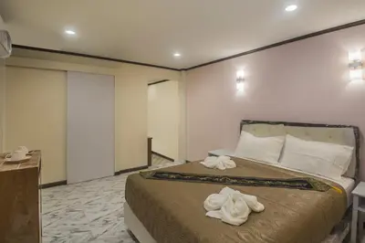 a bedroom with a bed with towels on it at Cana Boutique Hotel in Bangkok
