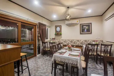 a dining room with a table and chairs at Cana Boutique Hotel in Bangkok