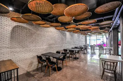 a row of tables and chairs in a restaurant at 7 Days Premium Hotel at Icon Siam Station - No Parking in Bangkok