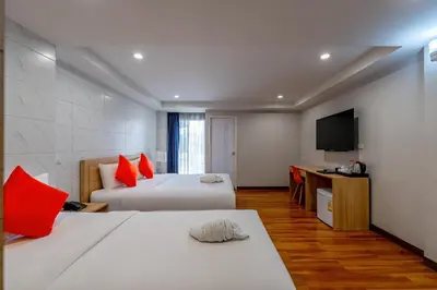 a hotel room with two beds and a television at 7 Days Premium Hotel at Icon Siam Station - No Parking in Bangkok