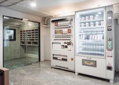 a vending machine in a room with drinks at China Cozy Asoke in Bangkok