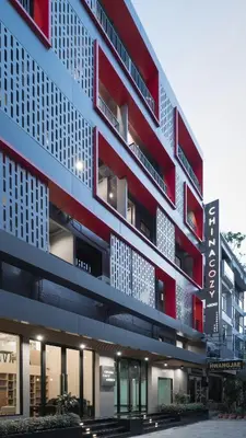 a red and white building with a lot of windows at China Cozy Asoke in Bangkok