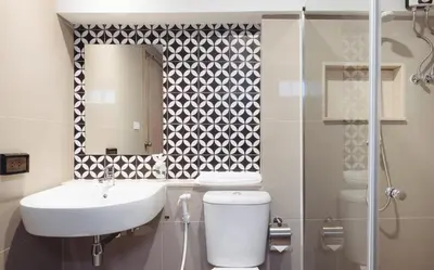 a bathroom with a sink and a toilet and a mirror at China Cozy Asoke in Bangkok