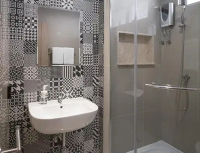 a bathroom with a sink and a shower at China Cozy Asoke in Bangkok