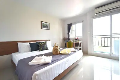 a bedroom with a large bed with towels on it at Ascella Sukhumvit 38 - Thonglor in Bangkok