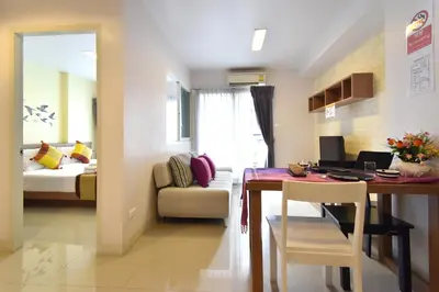 a room with a dining table and a bedroom at Ascella Sukhumvit 38 - Thonglor in Bangkok