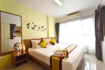 a bedroom with a bed and a large window at Ascella Sukhumvit 38 - Thonglor in Bangkok