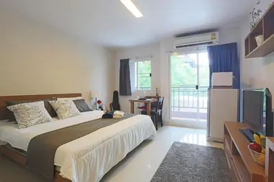 a bedroom with a large bed and a television at Ascella Sukhumvit 38 - Thonglor in Bangkok