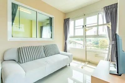 a living room with a couch and a window at Ascella Sukhumvit 38 - Thonglor in Bangkok