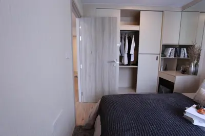 a small bedroom with a bed and a closet at Comfy Condo On Nut in Bangkok