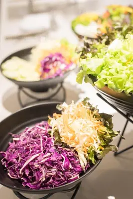 a table topped with bowls of different types of vegetables at Madison Bangkok Hotel in Bangkok