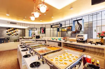 a buffet line with many different types of food at Baron Residence Bangkok in Bangkok