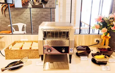 a toaster oven sitting on top of a counter at Baron Residence Bangkok in Bangkok